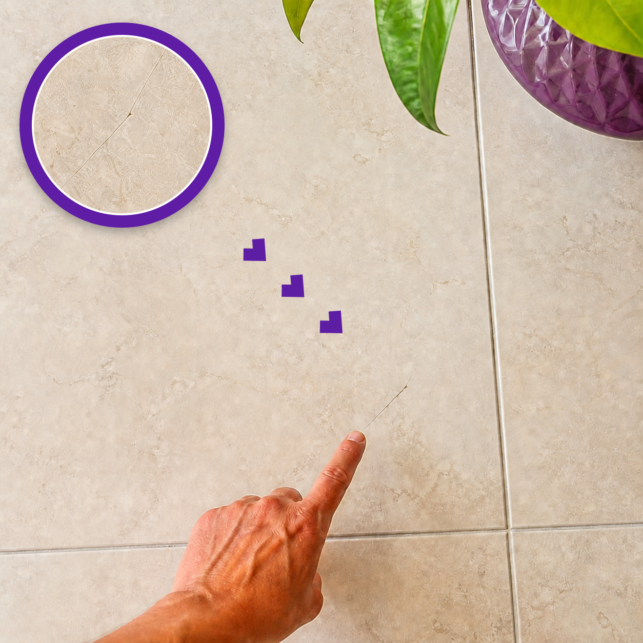 Crack in a warm ivory porcelain floor tile with a sharp high-resolution magnified close-up and a hand pointing nearby